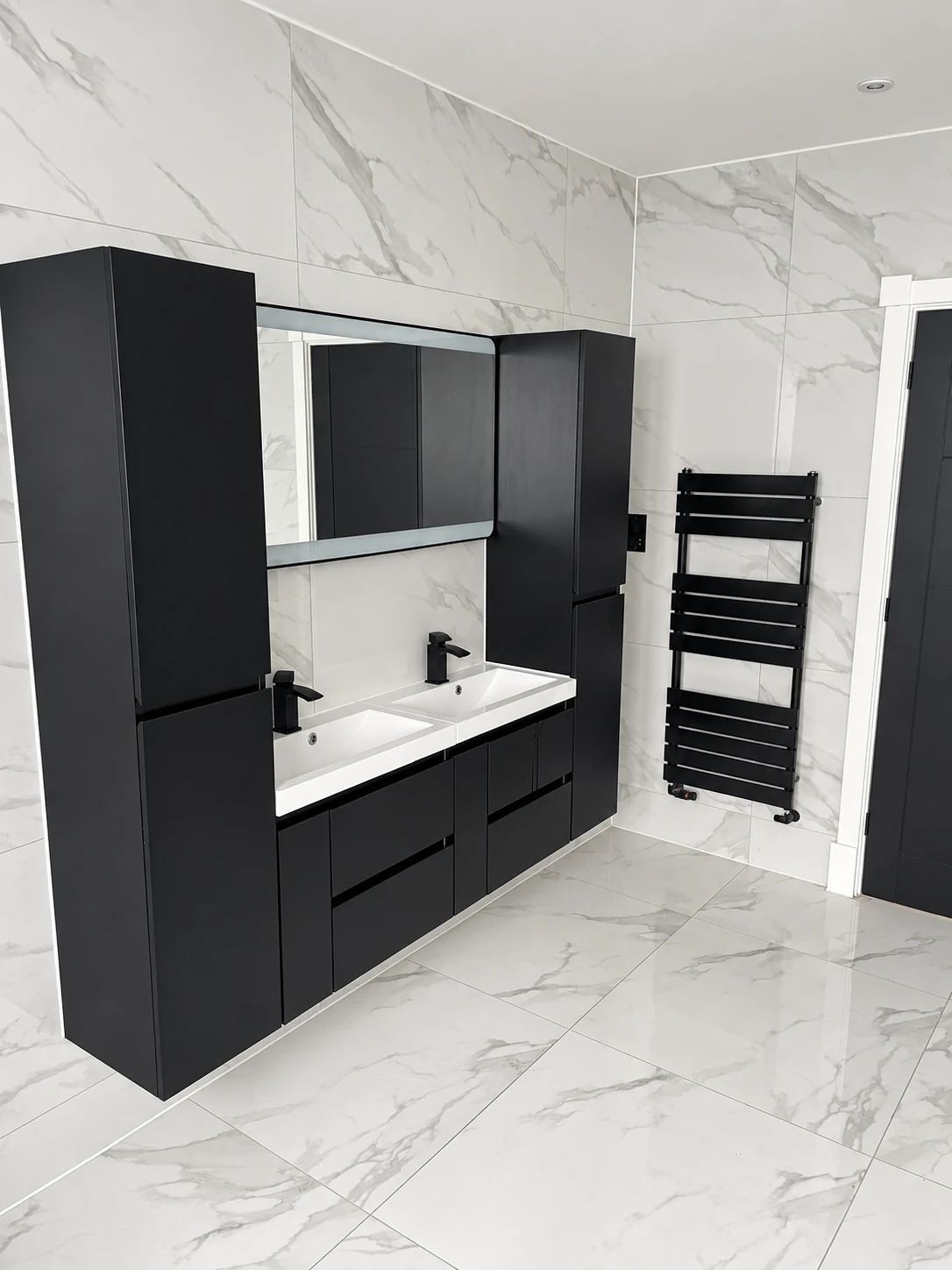 Black double vanity and tall storage beside a matching towel radiator